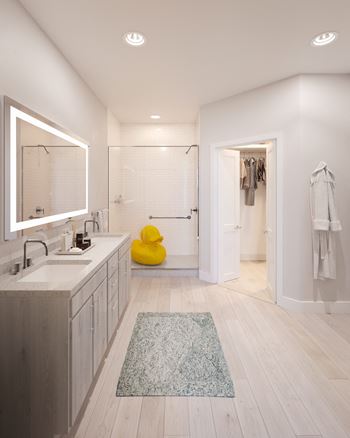 Ensuite bathrooms with walk-in showers, illuminated mirrors, and double sinks